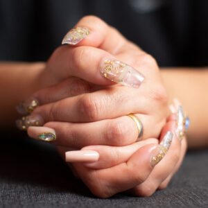 A closeup shot of female hands with trendy glossy manicure on her nails