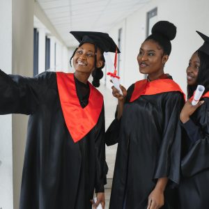 graduates holding diploma
